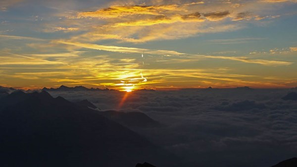 Snowshoeing at sunset with Trek Alps Guides