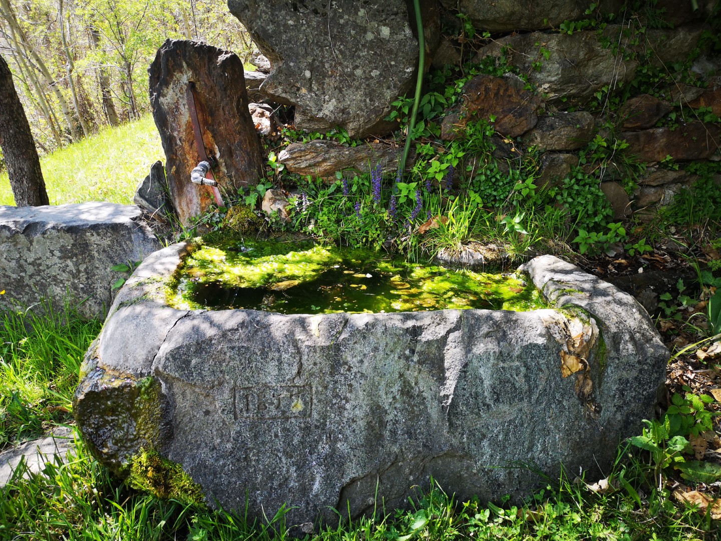 fountain carved into the rock  beyond the Marine village (Perloz)